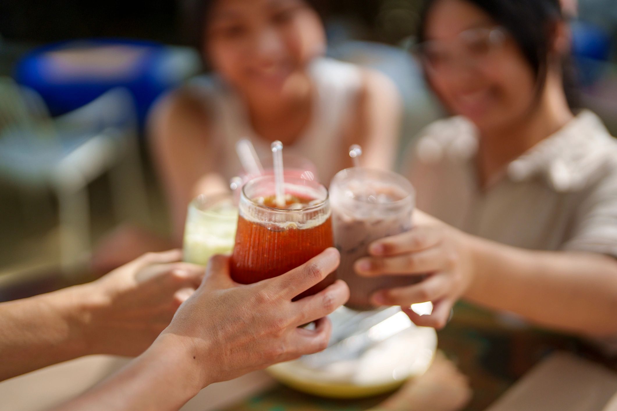 Guests toasting with drinks at an outdoor reception